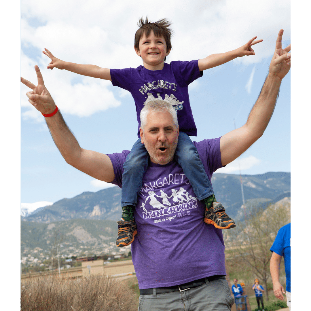 Colorado Springs Walk for ALS. Dad and Kid holding up peace signs.